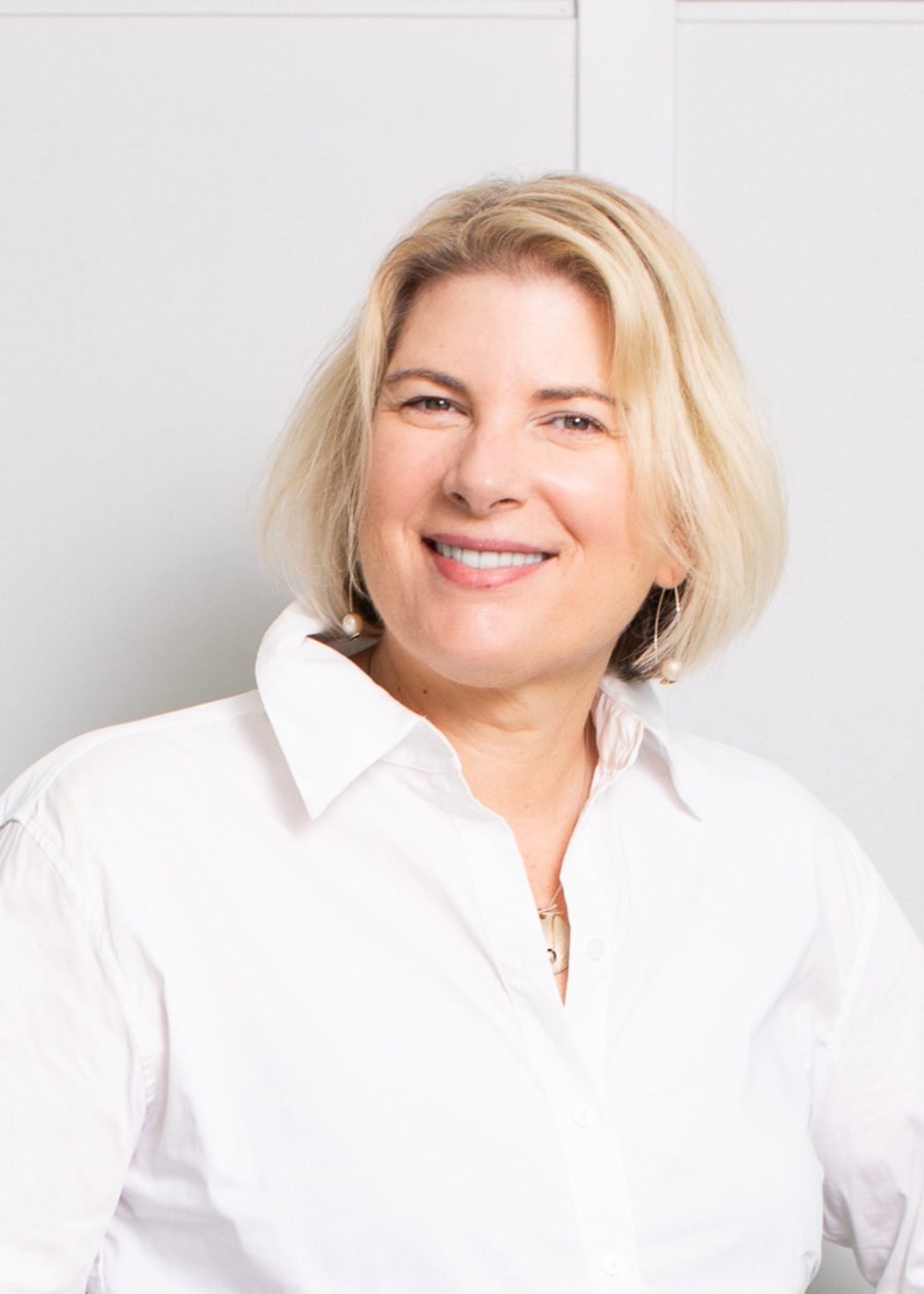Kathryn Giudes in a white shirt against a plain light background
